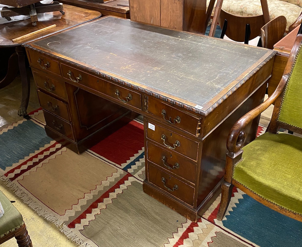 An early 20th century Chippendale revival mahogany pedestal desk, requiring restoration, length 135cm, depth 79cm, height 73cm